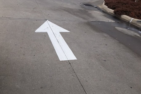 Directional Arrow White Painted In Parking Lot Greenville, SC